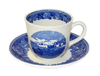 white tea cup with blue image of fort and saucer with blue rim