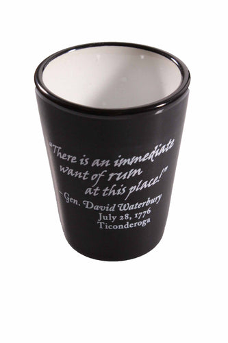 black shot glass with white text